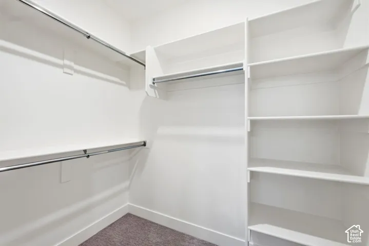 Custom closet system featuring multiple shelves and hanging rods