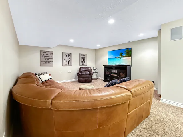 Recessed lighting illuminates the carpeted room