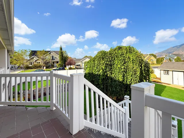 Paver patio with white railing and steps