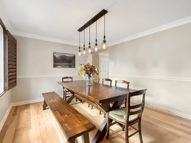 Light wood-finish flooring with crown molding and chair rail detailing