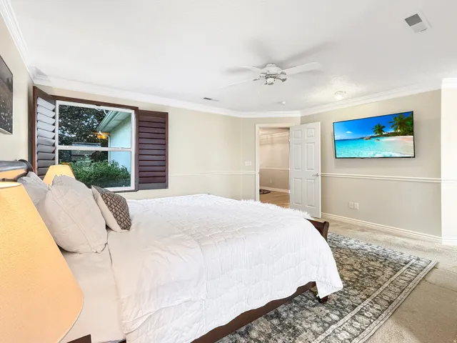 Crown molding, chair rail molding, ceiling fan, window with shutters, built-in display