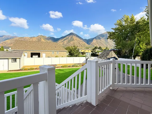 Outdoor decking with white railings and stairs