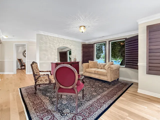 Hardwood flooring, crown molding, chair rail molding, recessed lighting, and plantation shutters