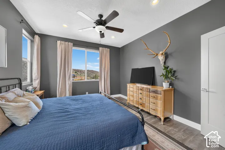 Recessed lighting, ceiling fan, and multiple windows providing ample natural light