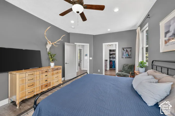 Recessed lighting, wood-finish ceiling fan, and large window with white trim