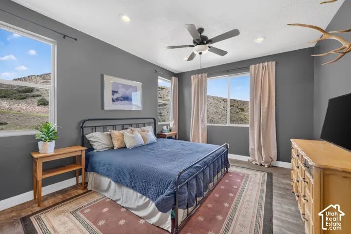Wood-finish flooring, recessed lighting, and a ceiling fan with integrated lighting