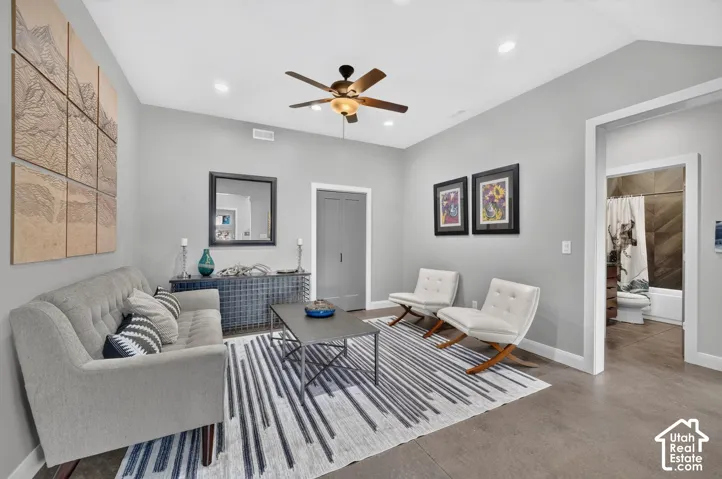 Vaulted ceiling with a ceiling fan, recessed lighting, and light gray wall paint