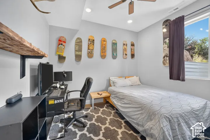 Recessed lighting, ceiling fan, window with privacy blinds, wood-finish flooring, and light gray wall paint