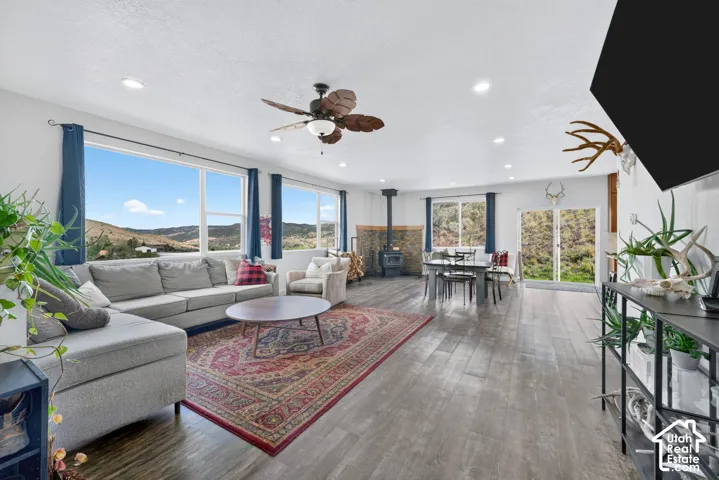 Open-concept living area featuring wood-finish flooring, recessed lighting, and a ceiling fan