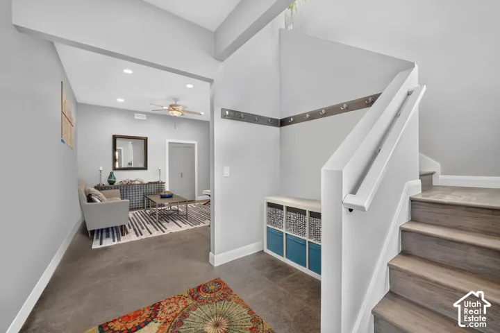 Staircase with wood-finish treads and white risers, accompanied by a built-in bench with storage cubbies