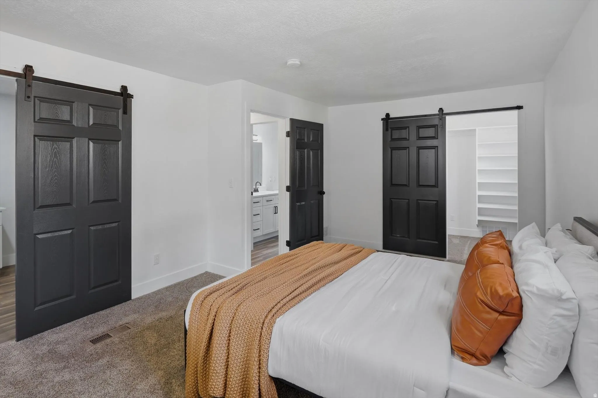 White walls with dark accent doors and coordinating hardware