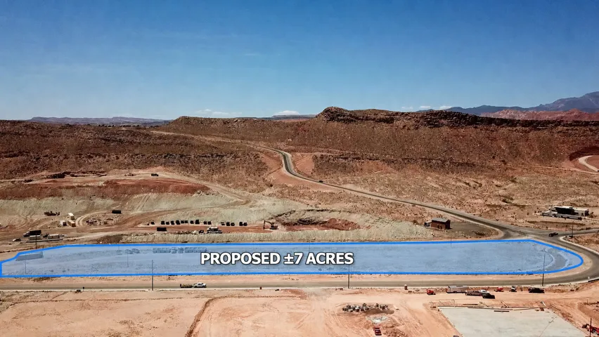 Proposed 7-acre parcel with surrounding desert landscape and paved road access