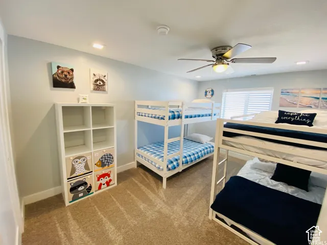 Neutral wall color, recessed lighting, ceiling fan, carpet flooring, window with horizontal blinds