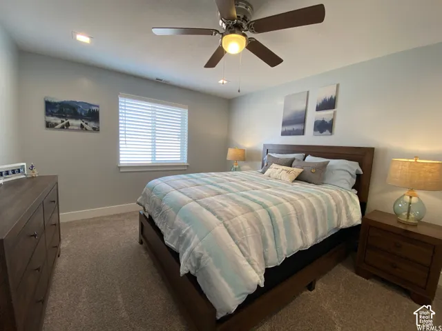 Neutral wall color, window with blinds, recessed lighting, and a ceiling fan with integrated lighting