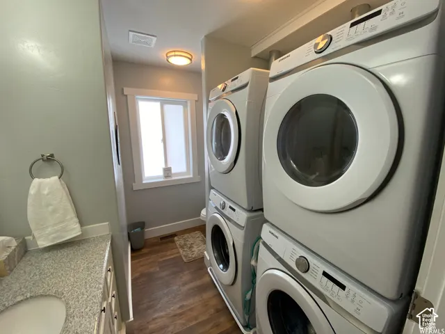 Wood-finish flooring, built-in window, and a vanity with a granular countertop