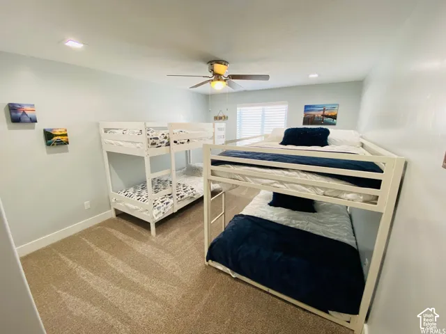 Recessed ceiling lighting, ceiling fan, carpeted flooring, and window with blinds