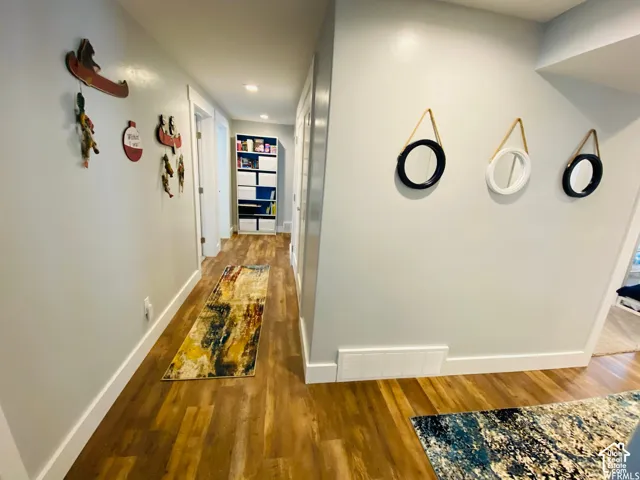 Wood-finish flooring throughout the hallway