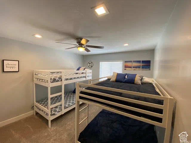 Recessed lighting, ceiling fan, window with blinds, and carpeted flooring