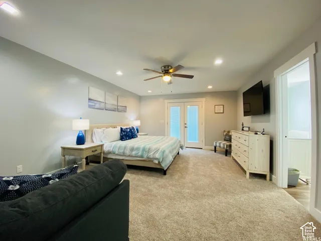 Carpeted room with recessed lighting, ceiling fan, and double French doors with internal blinds