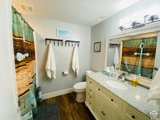 Vanity with an integrated sink, light-toned countertop, and undermount cabinet storage