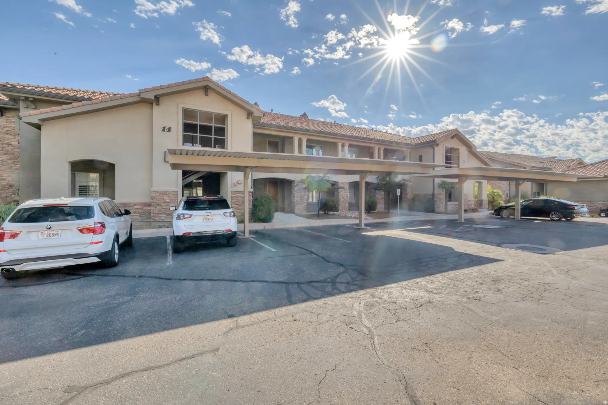 Multi-unit building featuring a stucco exterior and stone accents