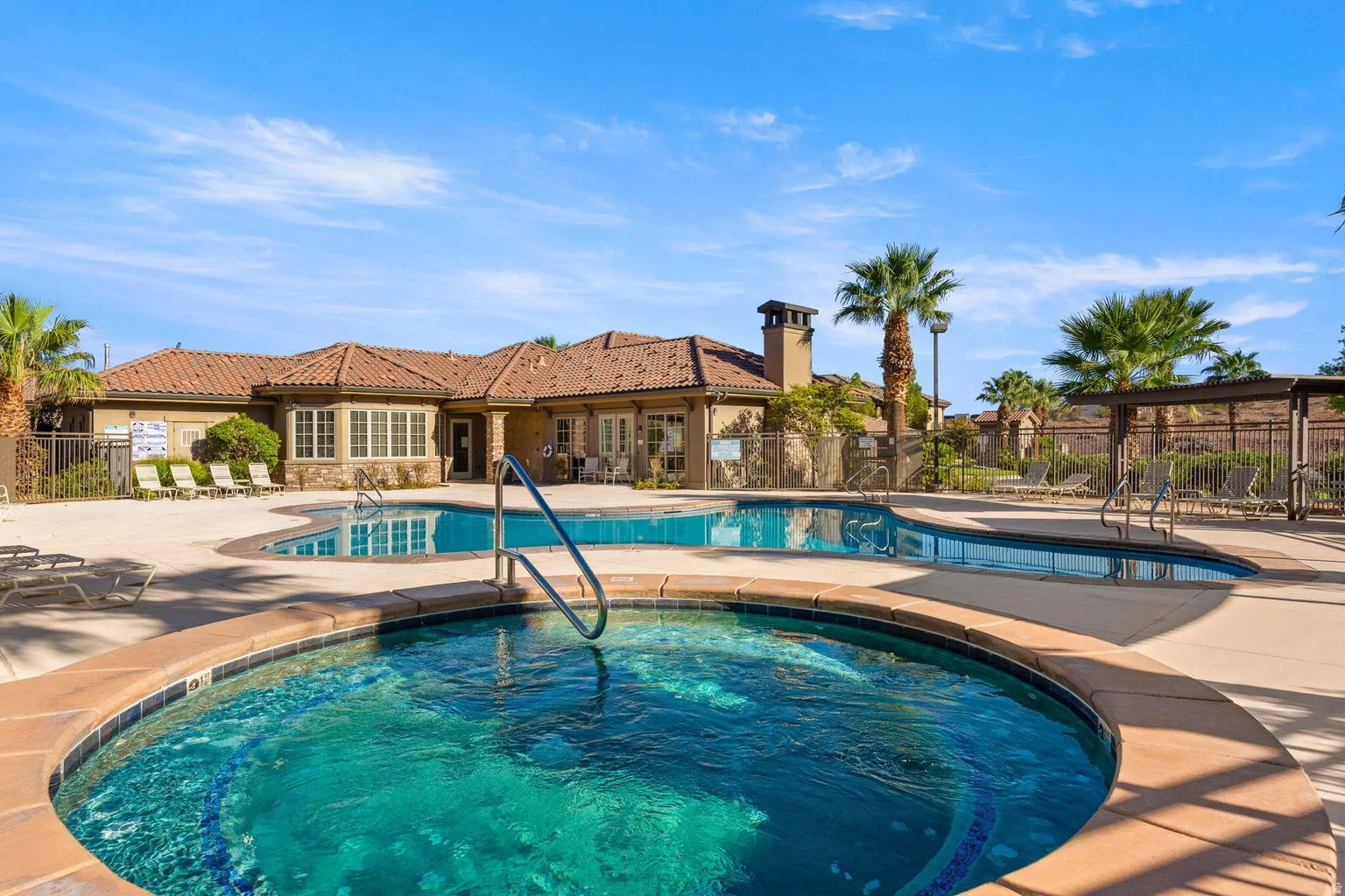 Resort-style pool with integrated spa and surrounding hardscaping