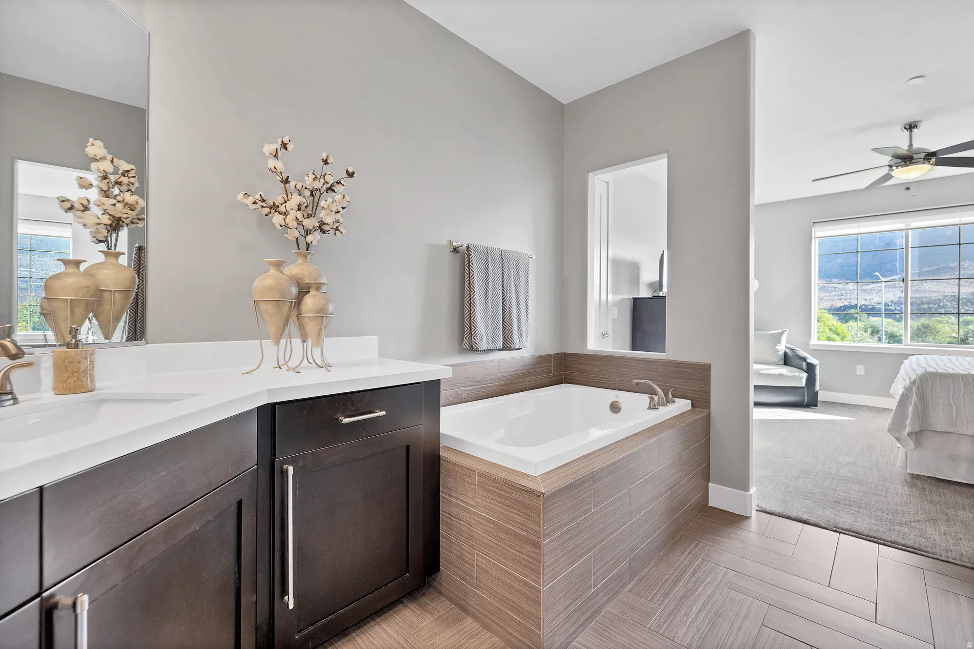 Dual vanity with white countertop, undermount sinks, and bronze-finish fixtures