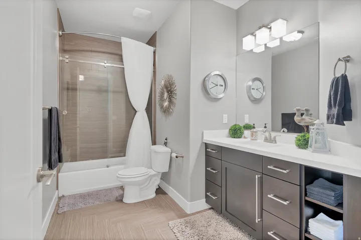 Bathroom featuring a spacious vanity with an integrated sink, ample storage cabinetry, and a framed mirror