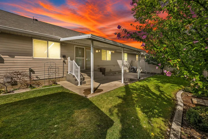 Covered patio with concrete flooring, exterior siding, and mature landscaping