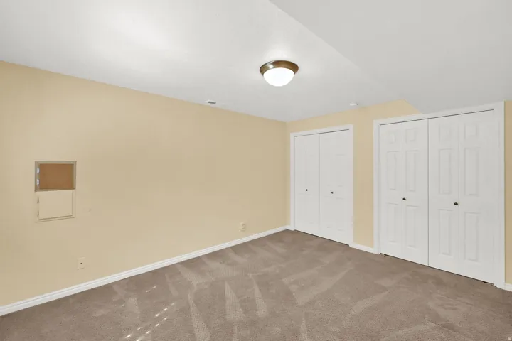 Recessed lighting fixture, two sets of bi-fold closet doors, wall-to-wall carpeting, and painted walls