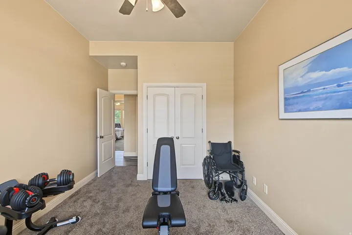 Neutral-toned walls complement the textured gray carpeting