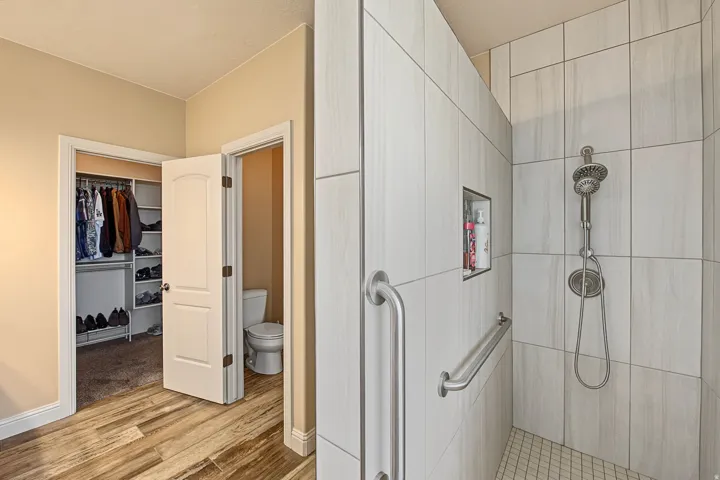 Shower with tile surround, built-in niche, and grab bars