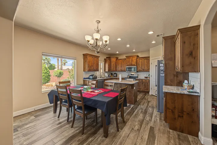 Spacious kitchen with wood-finish flooring, recessed lighting, and a kitchen island with seating