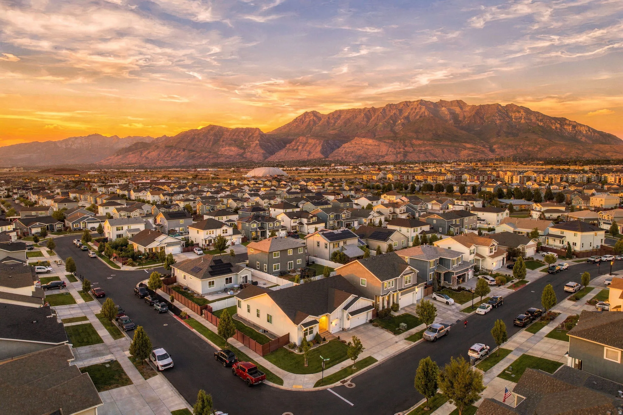 Mountain backdrop, residential area, paved streets, sidewalks, and street trees