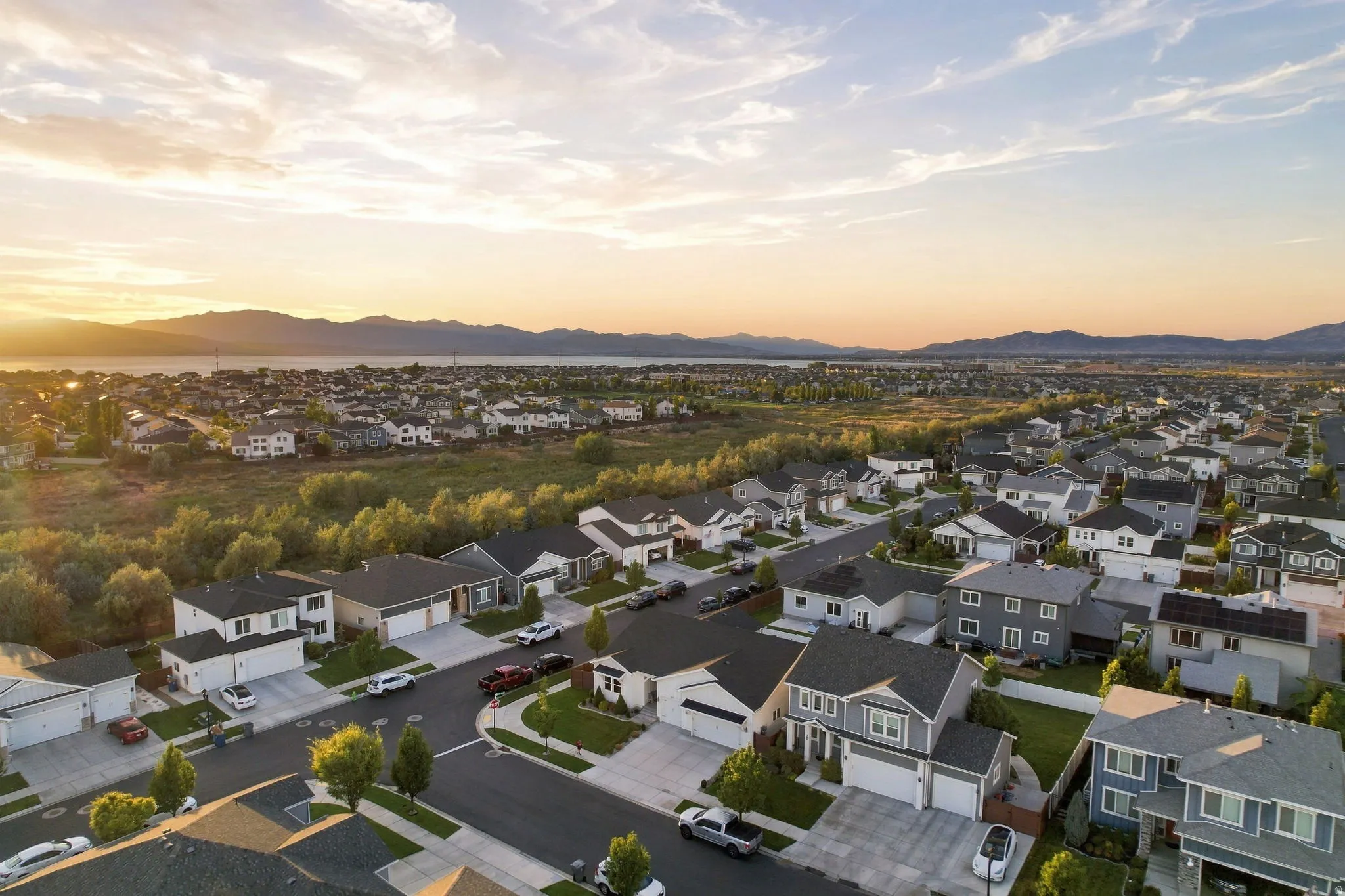Residential area with a variety of architectural styles, paved streets, and landscaped lots
