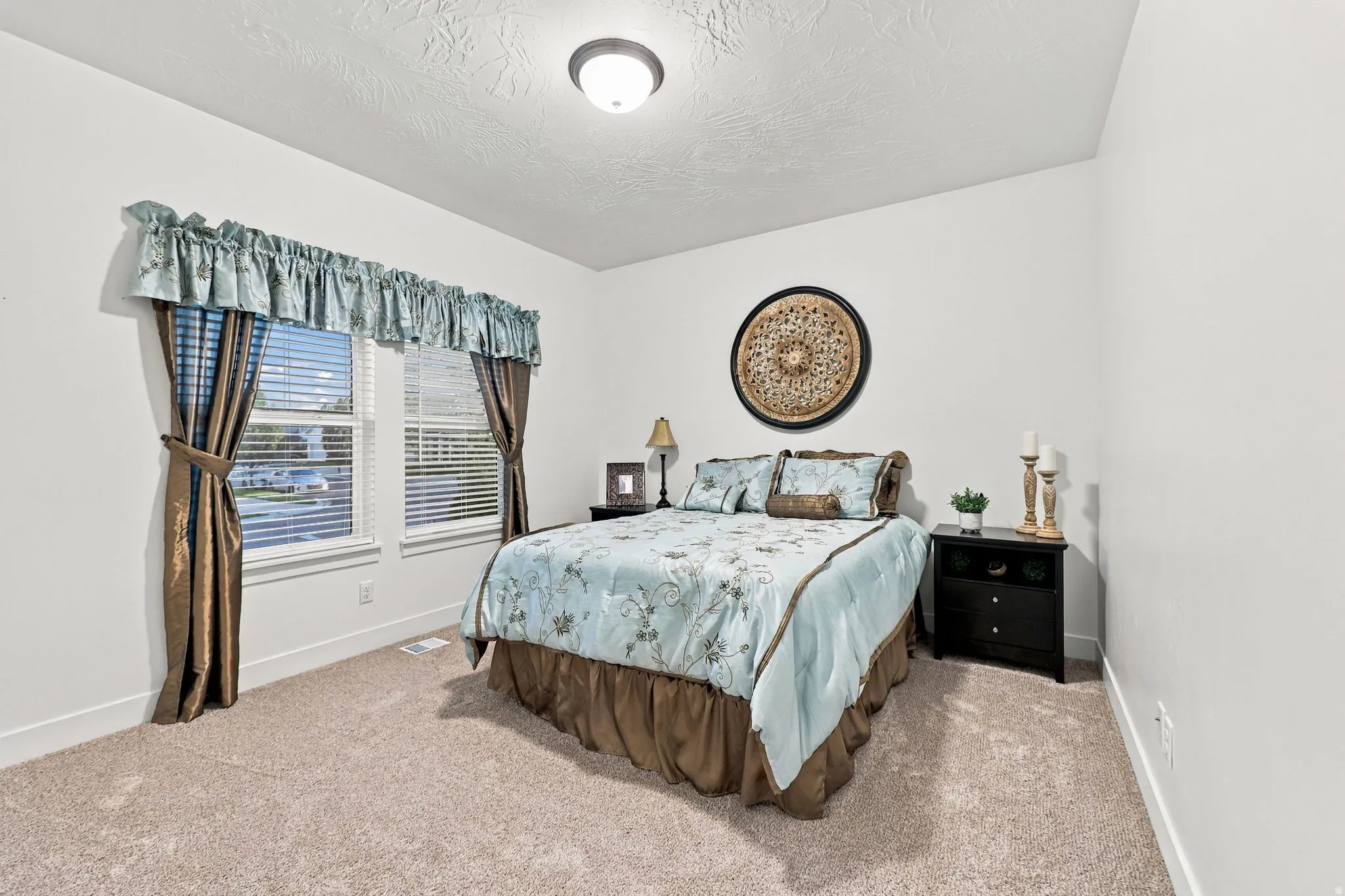 Wall-to-wall carpeting, dual windows, and an overhead flush-mount light fixture