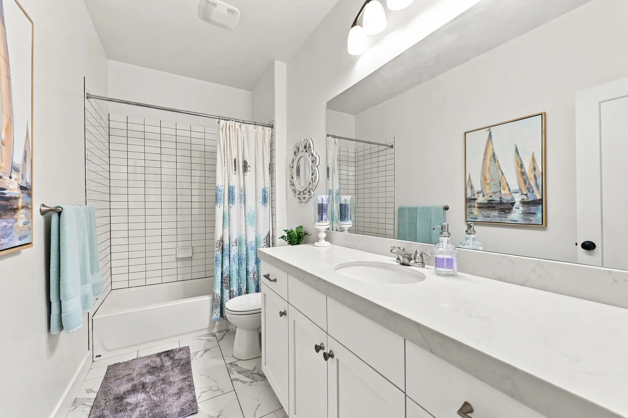 Extended single vanity with an integrated sink, white cabinetry, and a full-width mirror