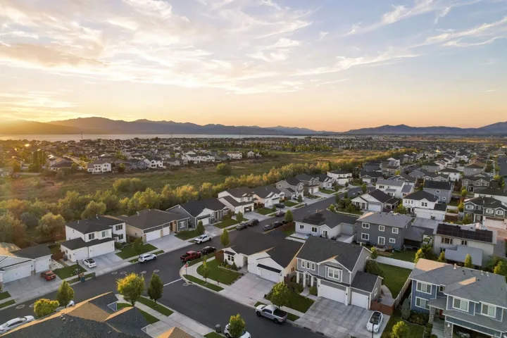 Residential area with a variety of architectural styles, paved streets, and landscaped lots