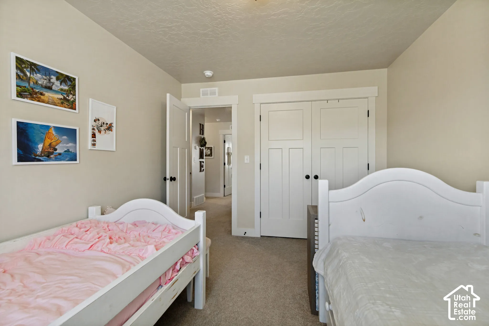 Carpeted flooring throughout, with a paneled interior door and matching bi-fold closet doors