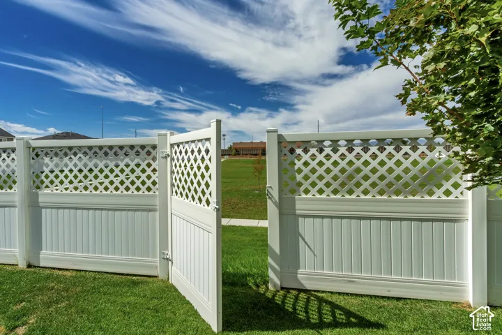 White vinyl fence with lattice top and a matching gate