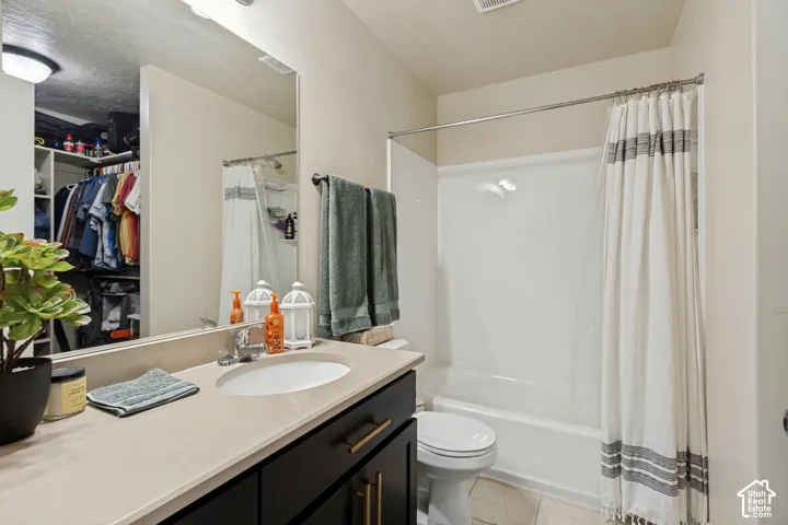 Master Bathroom with polished chrome faucet, and dark wood-finish cabinetry.