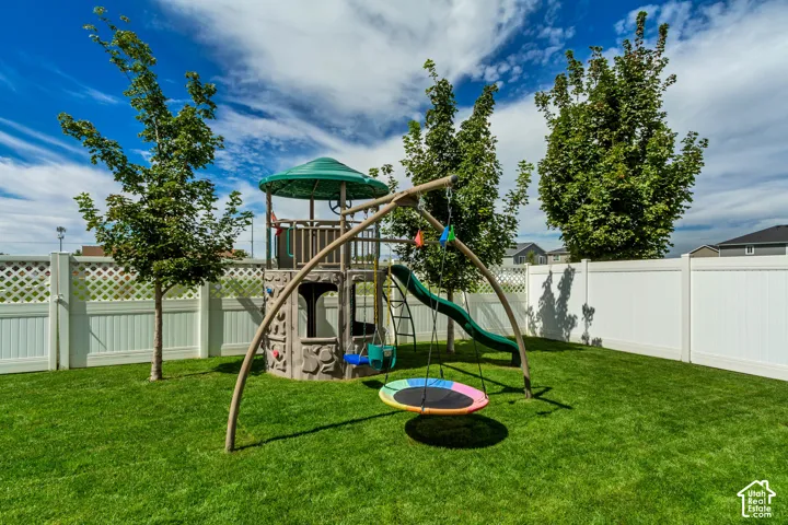 Expansive green lawn with a privacy fence