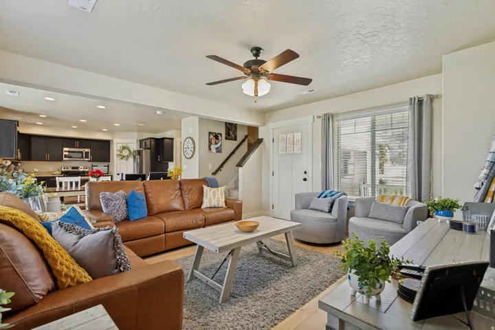 Open-concept living space with a ceiling fan, recessed lighting, and wood-finish flooring