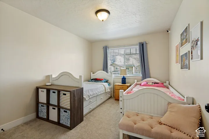 Bedroom. Wall-to-wall carpeting and a ceiling-mounted light fixture