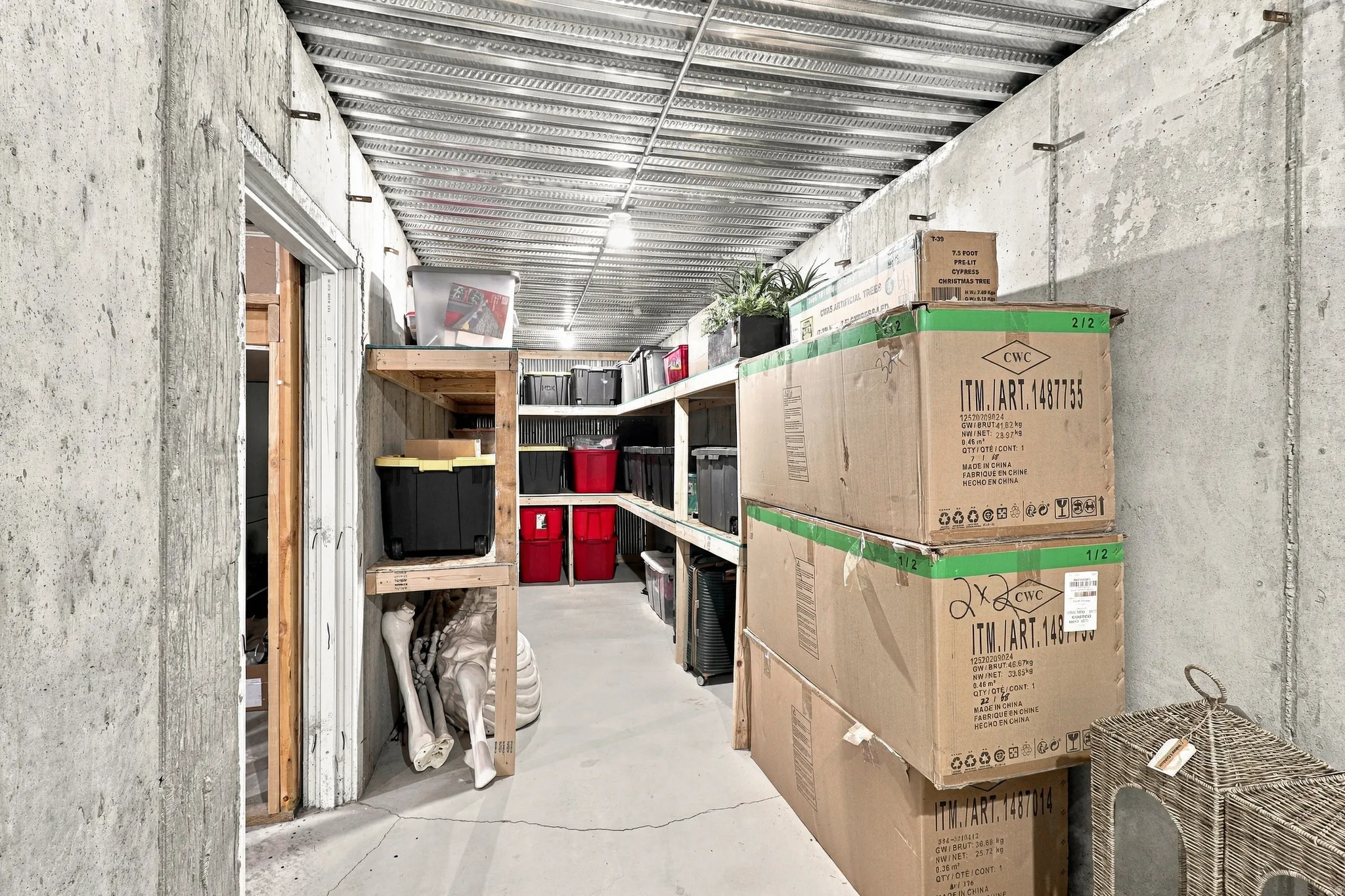 Concrete walls, metal ceiling, built-in wooden shelving, overhead lighting