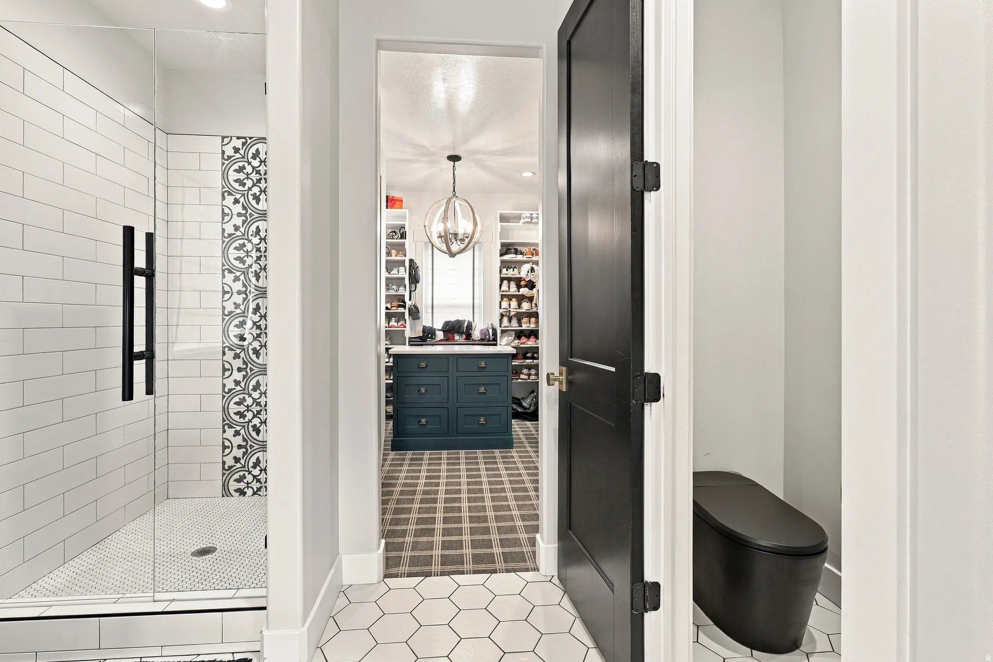 Walk-in shower with clear glass enclosure and black hardware