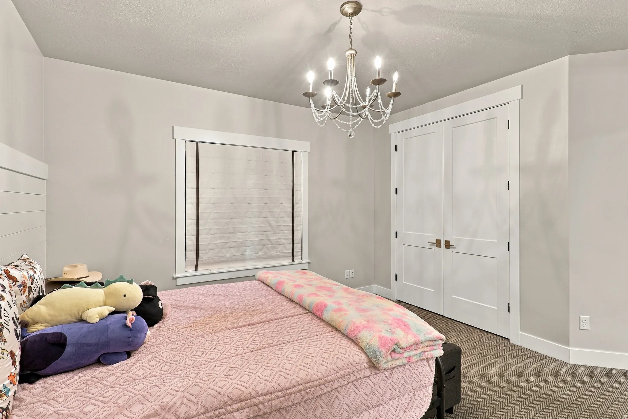 Recessed lighting, chandelier, neutral wall colors, window with white trim, and white double doors