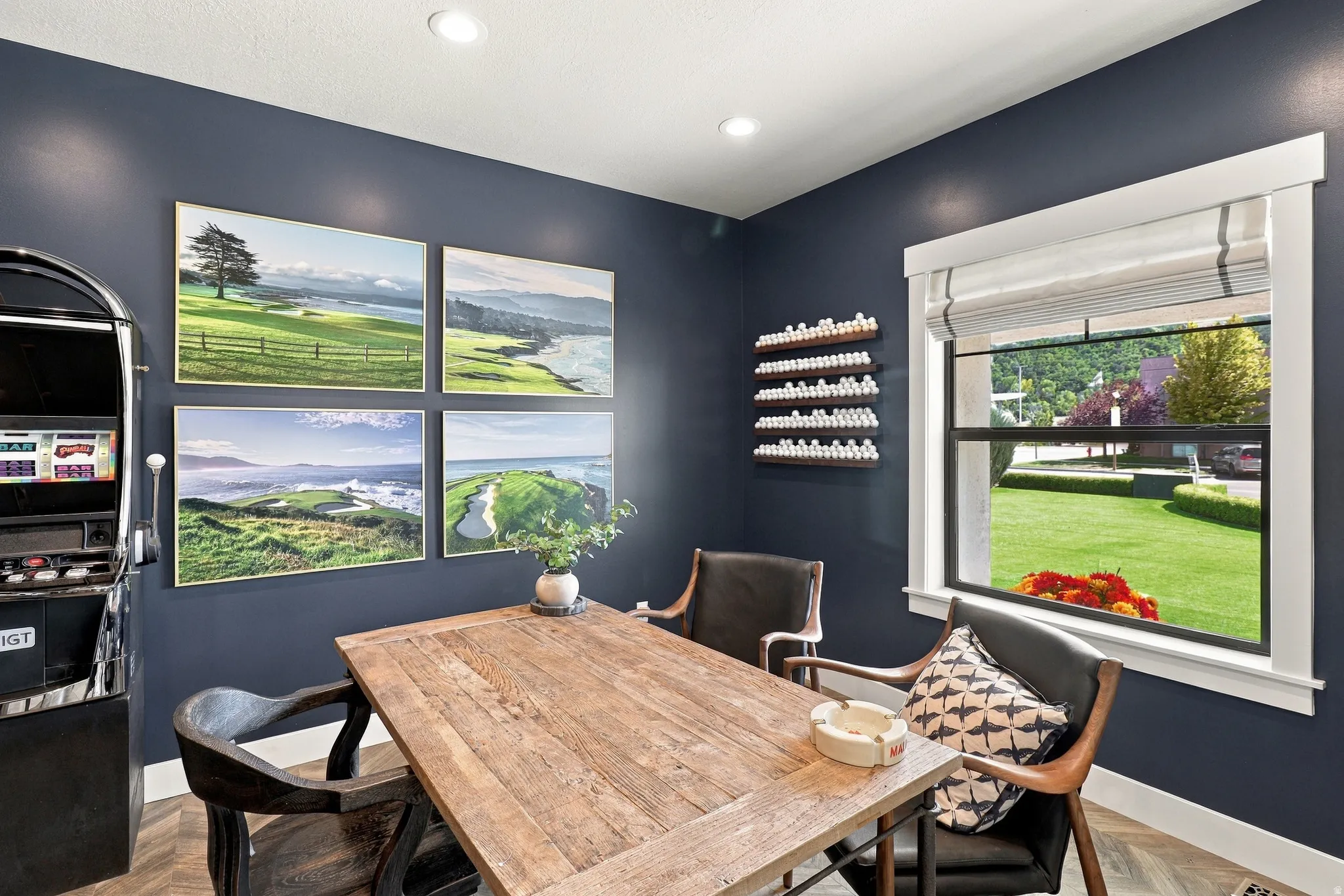 Recessed lighting, dark accent wall, window with white trim, wood-finish flooring, and a built-in shelving unit