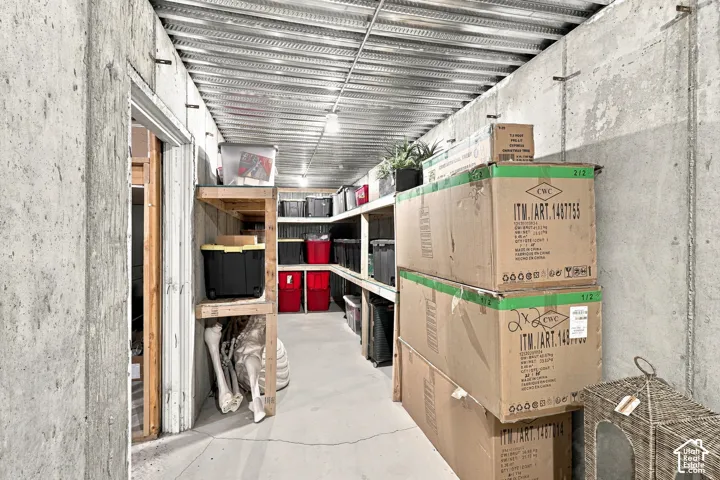 Concrete walls, metal ceiling, built-in wooden shelving, overhead lighting