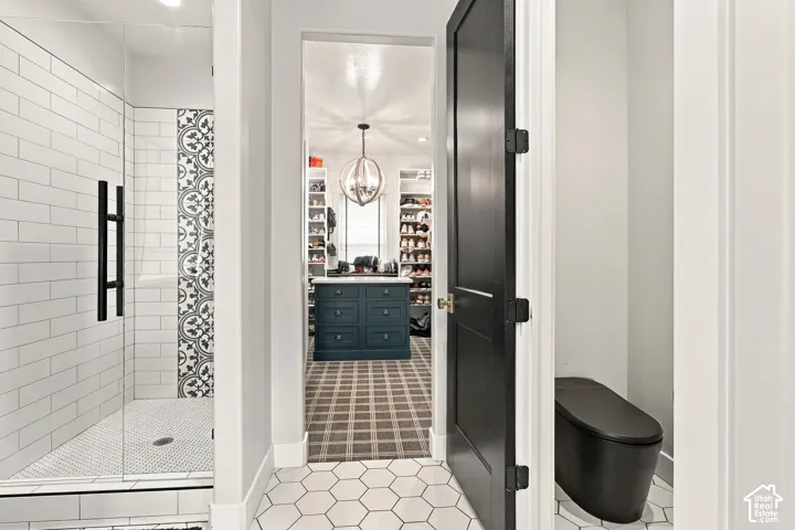 Walk-in shower with clear glass enclosure and black hardware
